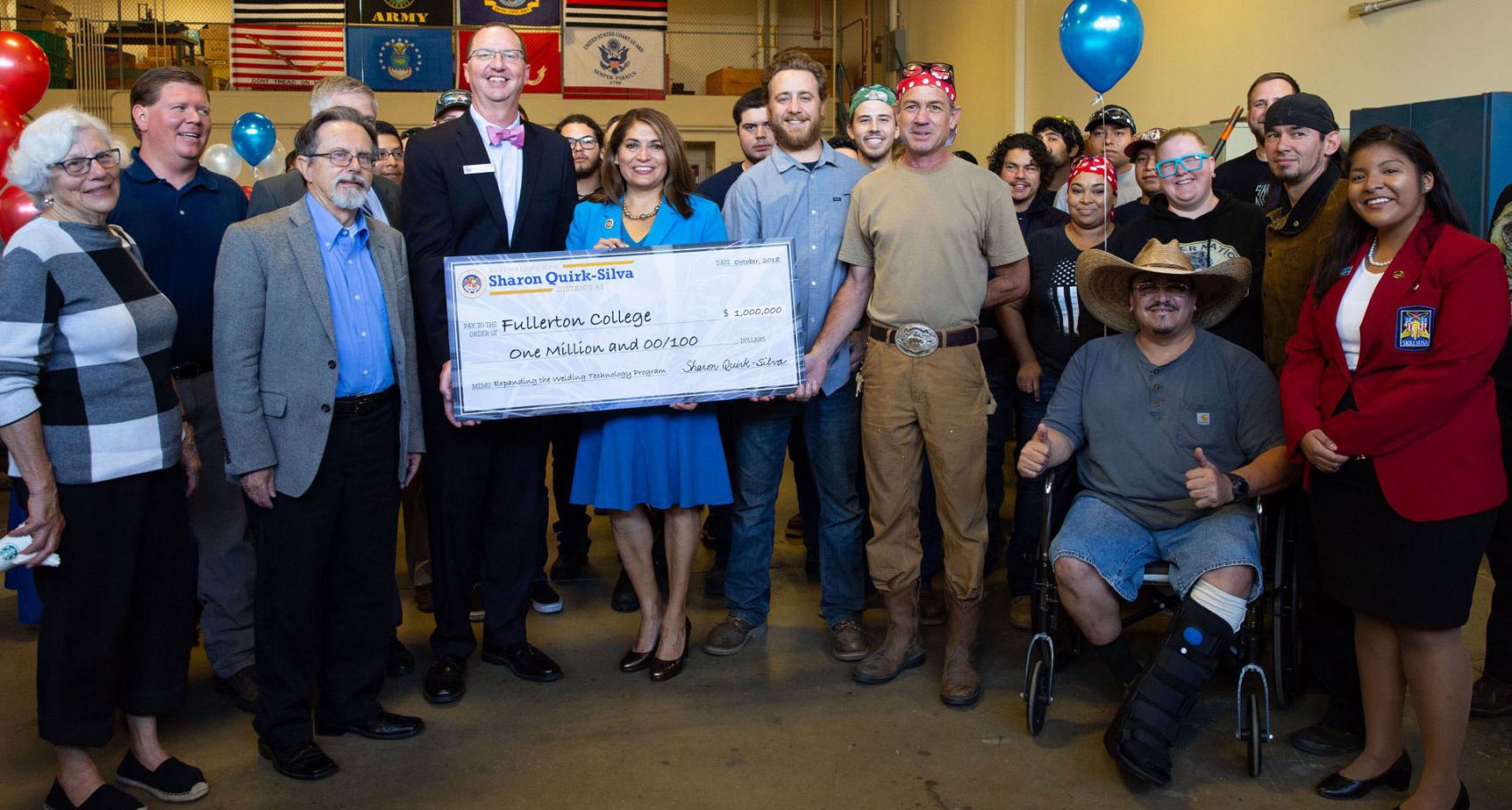 A group of people hold a ceremonial check for $1 million