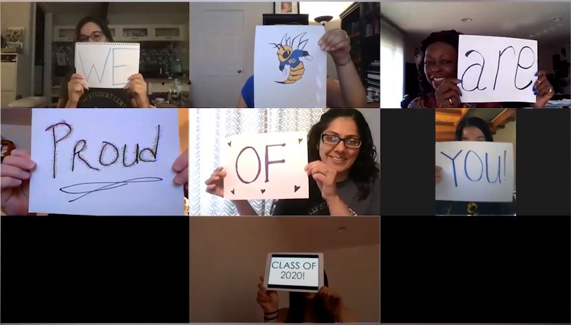 A zoom meeting with staff holding up signs that read "We are proud of you Class of 2020"