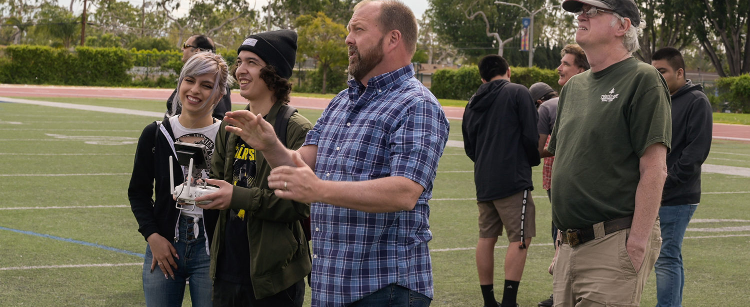 Professor Jay Seidel instructs students on flying drones.