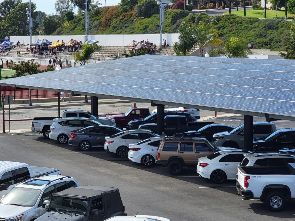 cars parked under solar powered canopy